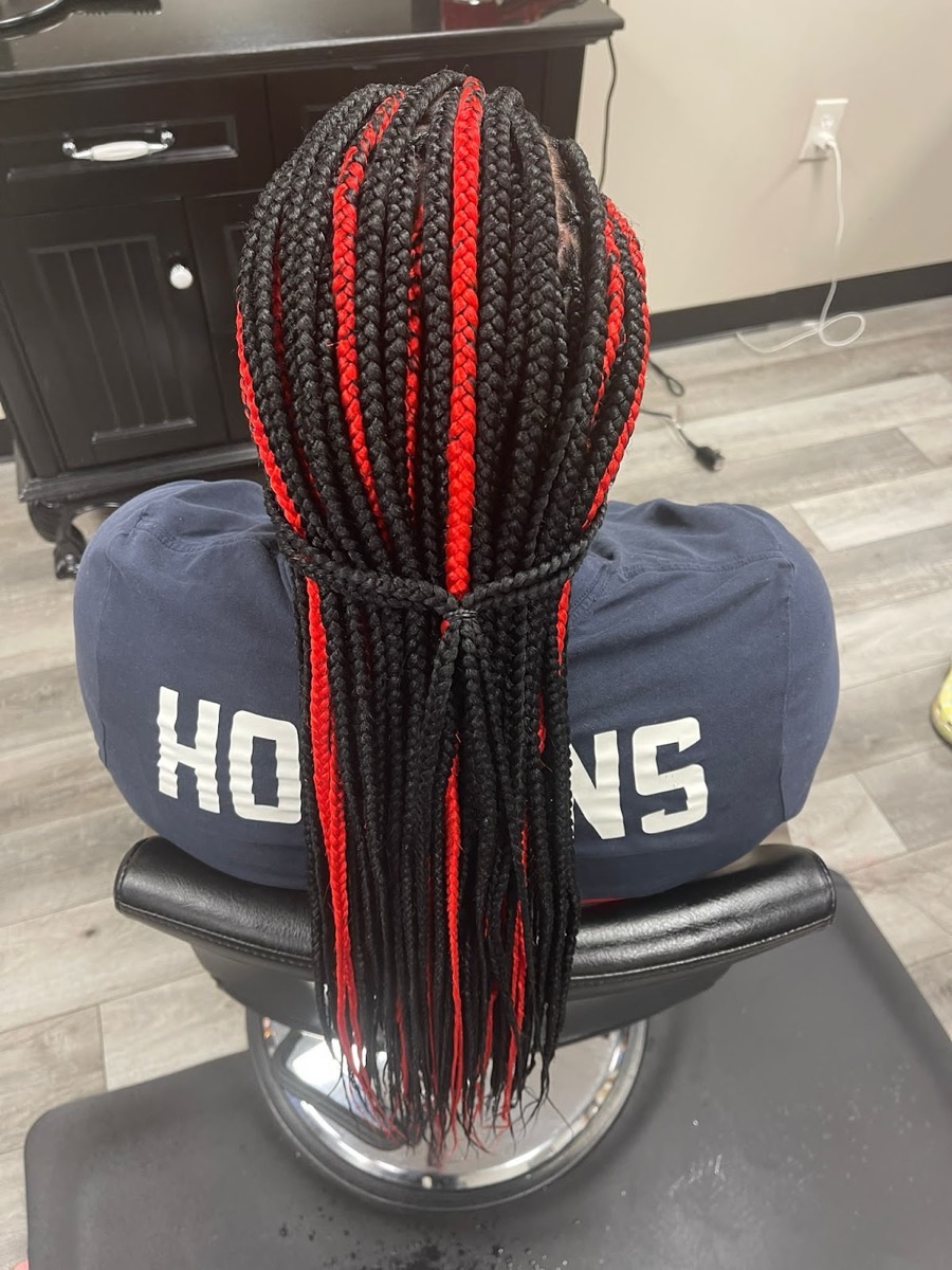 Red and black knotless box braids styled at the salon