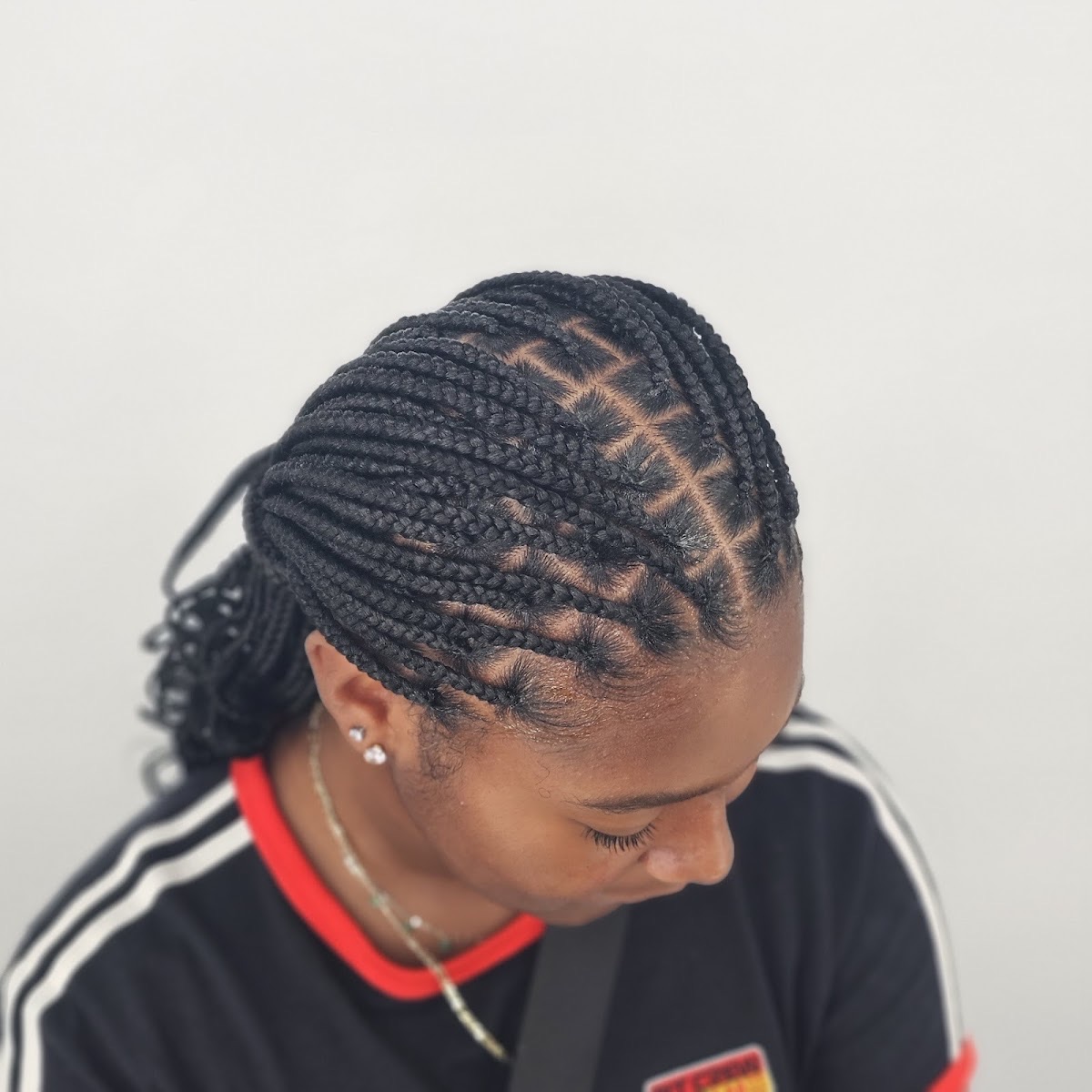 Neat knotless braids styled at Ngozi Hair Braiding in Stockbridge, GA
